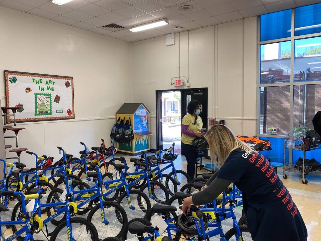 Houston Marketing Manager, Chelsea, arranges bicycles delivered by 3 Men Movers for Cycle Houston, a nonprofit that rewards students' improved literacy with bikes.